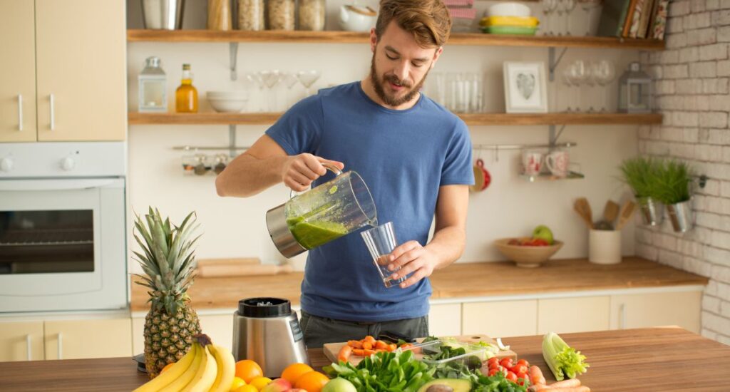 Man making a green smoothie for men's hormone health